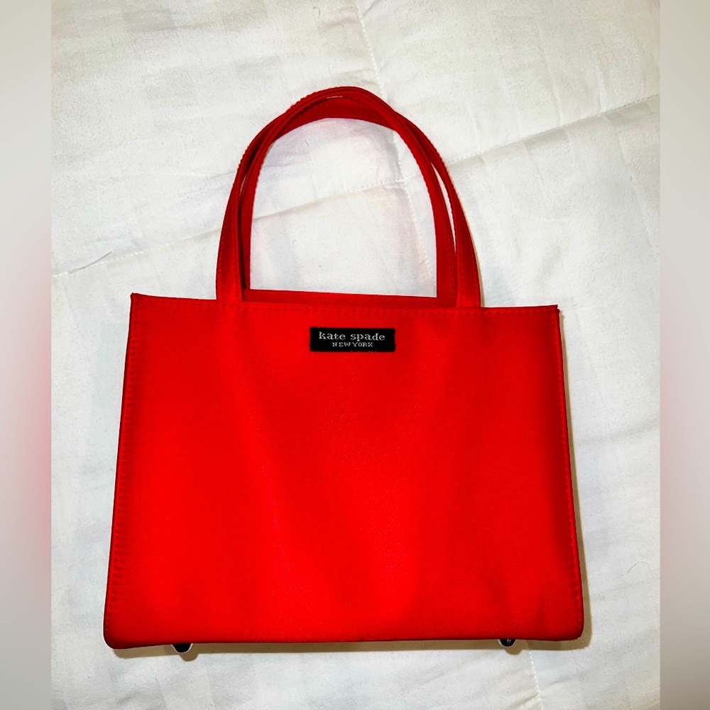 red Kate Spade bag. Small and beautiful. Approx  8” x 6” x 3.5” in
